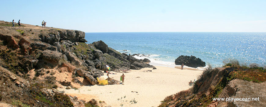 Sand between cliffs at Praia da Ilha do Pessegueiro Beach